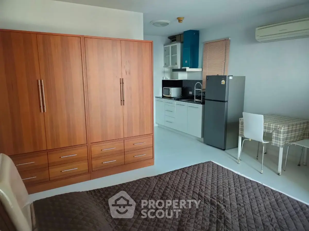 Cozy studio apartment with modern kitchen and ample storage space