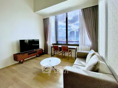 Modern living room with large window and city view, featuring stylish furniture and natural light.