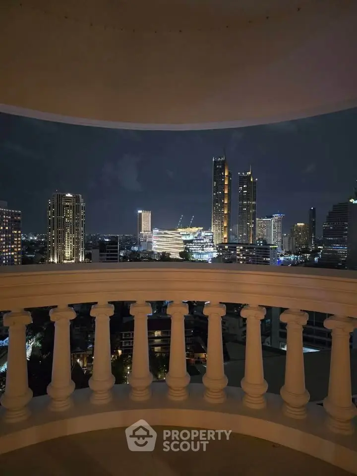 Stunning night cityscape view from a balcony with elegant balustrade, showcasing urban skyline lights.