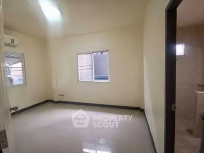 Spacious unfurnished room with tiled flooring and natural light, ideal for customization.