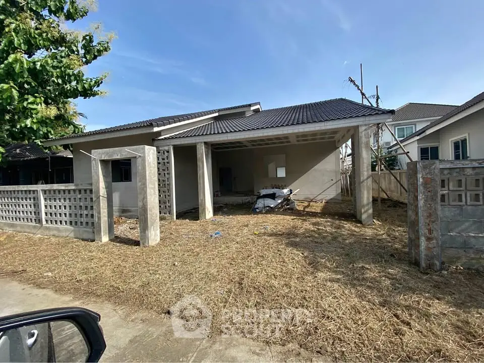 Charming single-story home with spacious front yard and modern architecture.