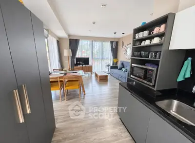 Modern open-plan kitchen and living room with sleek design and natural light.