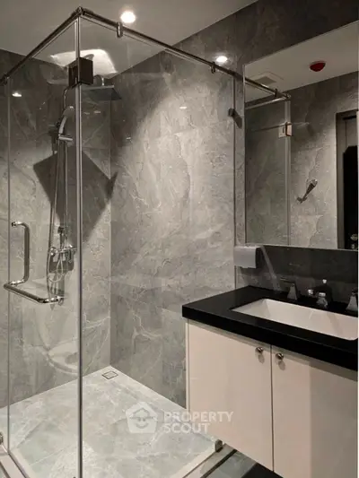 Modern bathroom with sleek glass shower and elegant marble tiles