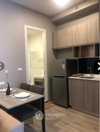 Modern compact kitchen with dining area and sleek cabinetry