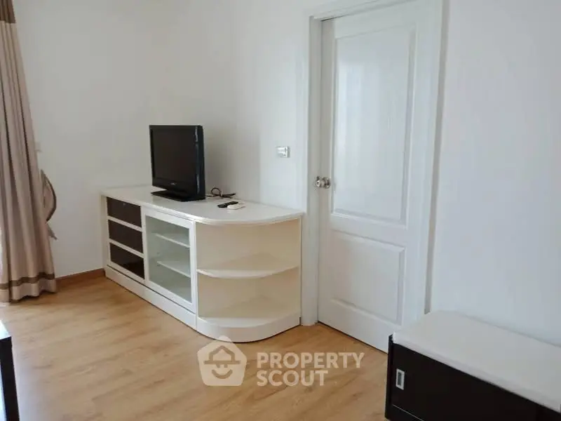 Modern living room with wooden flooring and sleek TV cabinet