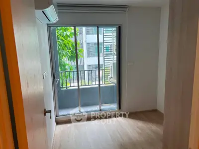 Cozy bedroom with balcony view and air conditioning in modern apartment