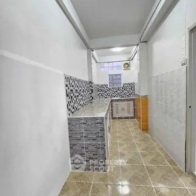 Spacious kitchen with tiled walls and ample counter space