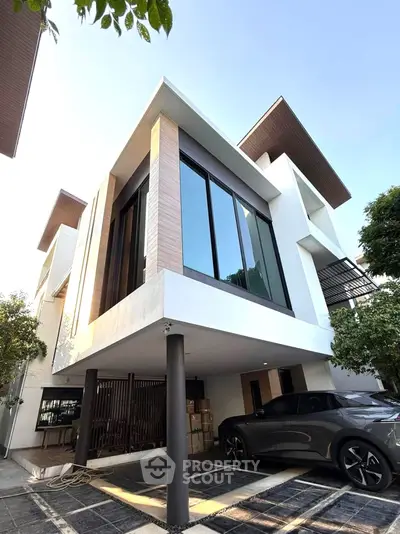 Modern architectural home with sleek design and spacious carport