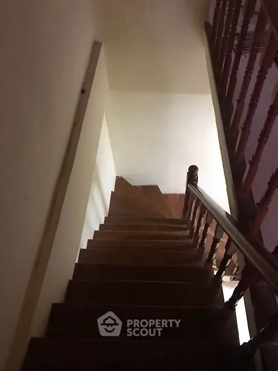 Elegant wooden staircase with classic railing in a cozy home interior