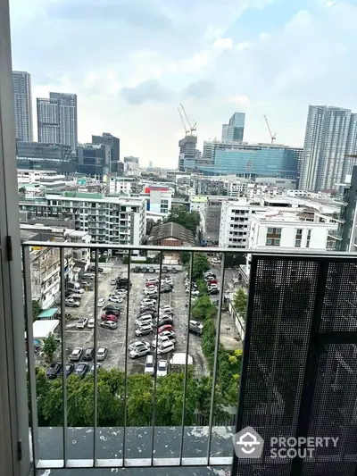 Stunning cityscape view from a high-rise balcony overlooking urban skyline and construction sites.