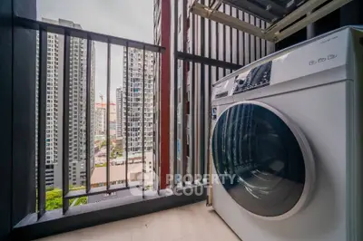Modern balcony with washing machine and city view in high-rise apartment.