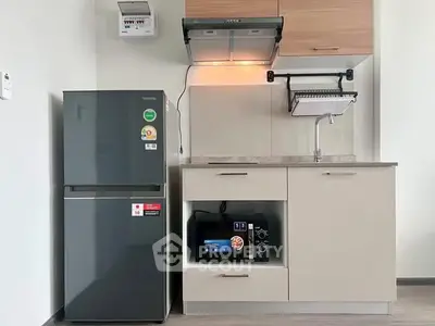 Modern compact kitchen with sleek appliances and efficient storage solutions.