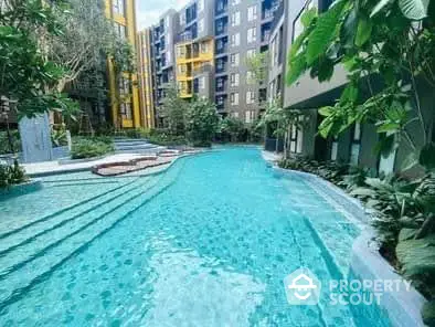 Luxurious apartment complex with stunning pool and lush greenery