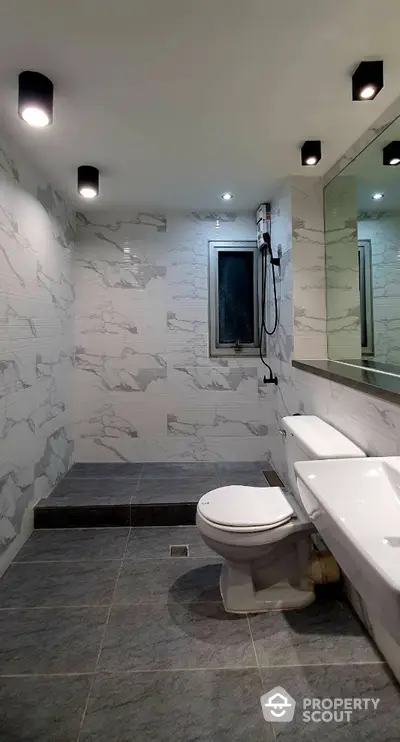 Modern bathroom with marble tiles and sleek fixtures