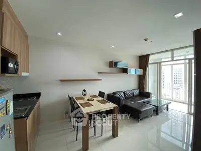 Modern living room with open kitchen and balcony view in a stylish apartment.