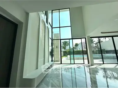 Stunning modern living room with floor-to-ceiling windows and pool view