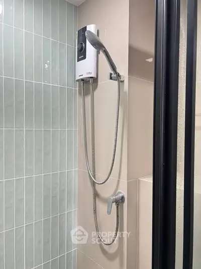 Modern bathroom shower with sleek design and tiled walls, featuring a high-quality showerhead.