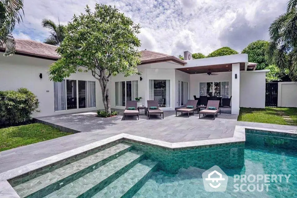 Luxurious modern villa with private pool and spacious patio in tropical setting