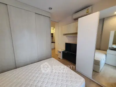Modern bedroom with sleek design, featuring built-in wardrobe and air conditioning for ultimate comfort.