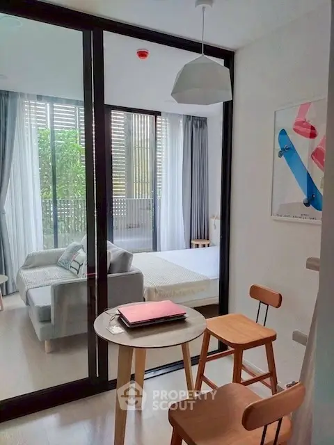 Modern apartment with cozy study area and view into stylish bedroom