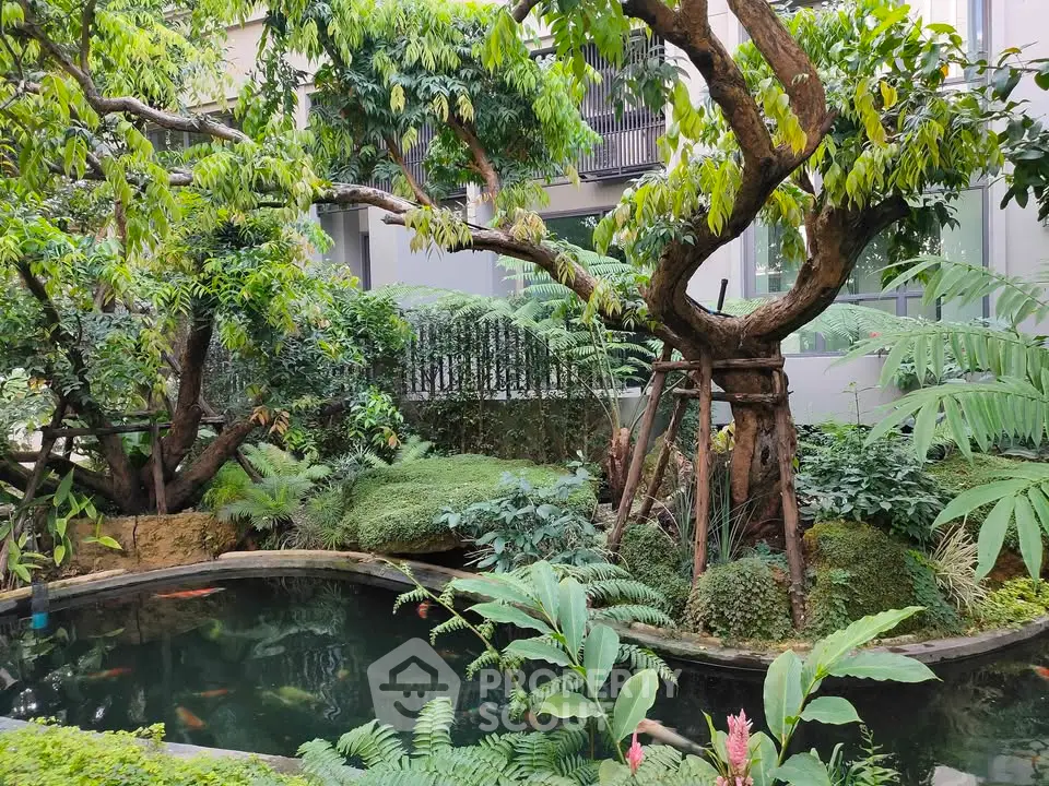 Lush garden with koi pond in modern residential complex