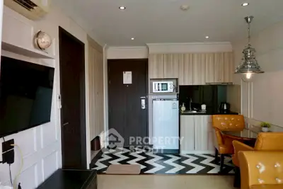Chic modern kitchen with stylish chevron flooring and cozy dining area.