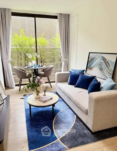 Stylish living room with modern decor, large window, and elegant furniture in a cozy apartment.