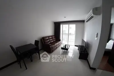 Modern living room with leather sofa, dining table, and balcony access in a stylish apartment.