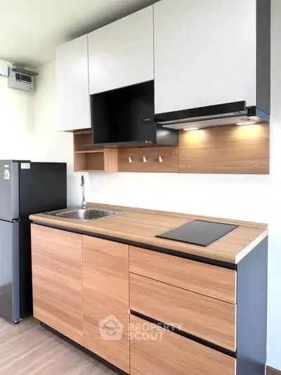 Modern kitchen with sleek cabinets and built-in appliances in a stylish apartment.