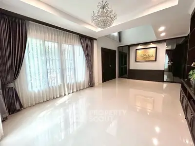 Spacious modern living room with elegant chandelier and large windows