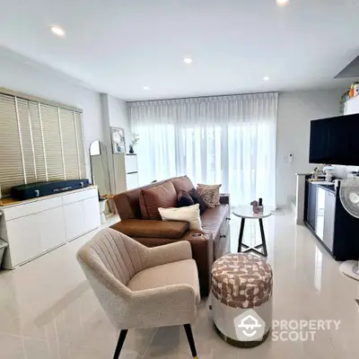 Modern living room with stylish furniture and large windows for natural light.