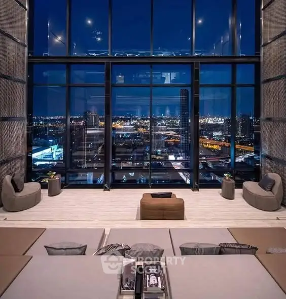 Luxurious high-rise living room with stunning cityscape view through floor-to-ceiling windows.