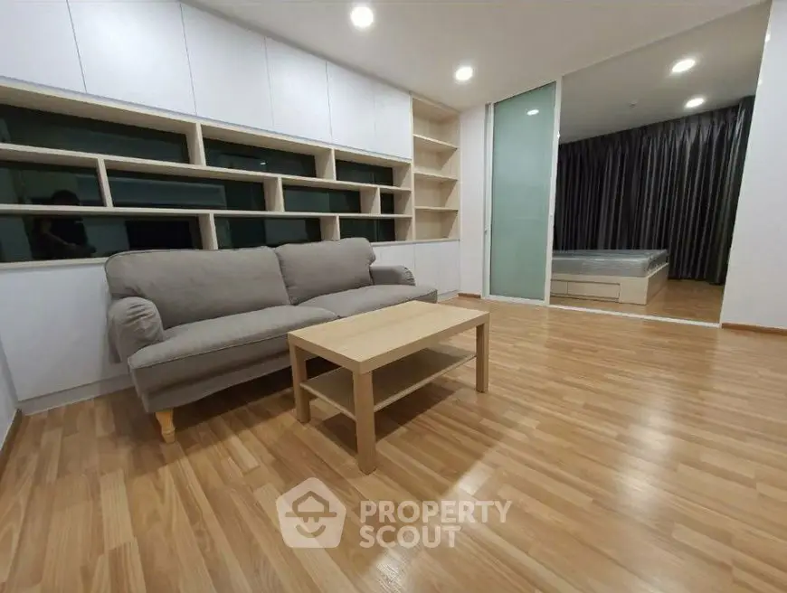 Modern living room with wooden flooring and cozy sofa