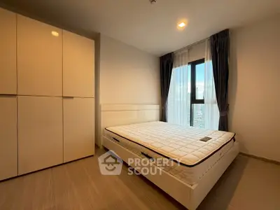 Modern bedroom with large window and sleek furniture