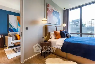 Modern bedroom with stylish decor and large window offering city view