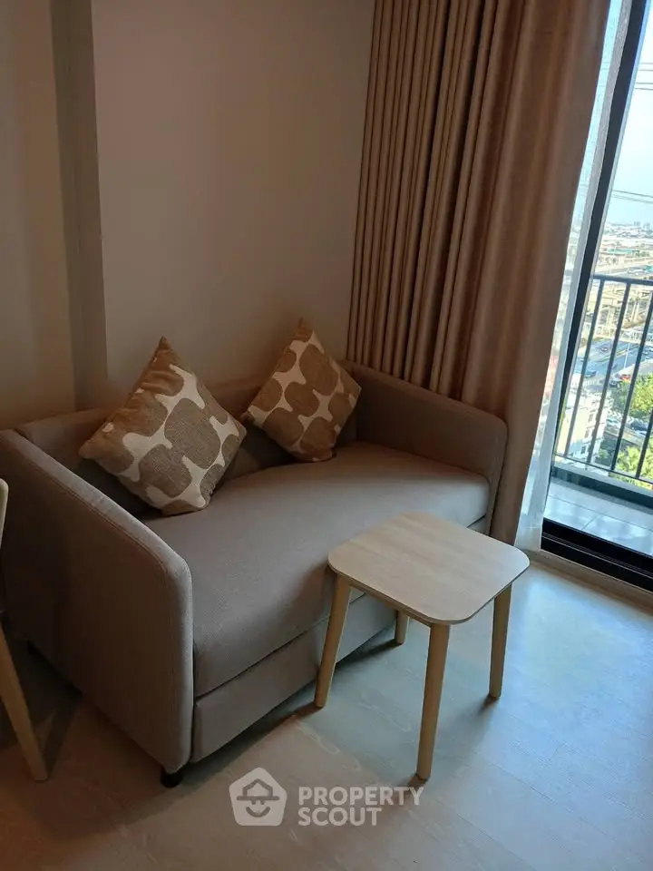 Cozy living room with stylish sofa and balcony view