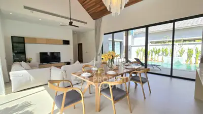 Luxurious open-plan living and dining area with pool view and modern decor
