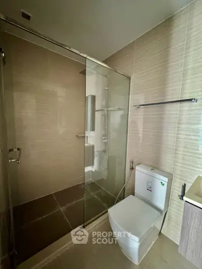 Modern bathroom with glass shower enclosure and sleek fixtures