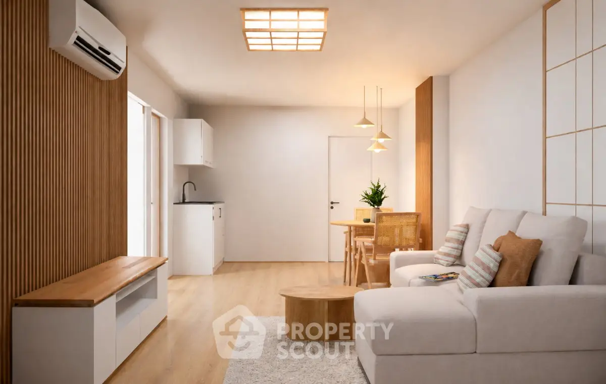 Modern living room with cozy seating and stylish decor in a bright apartment.