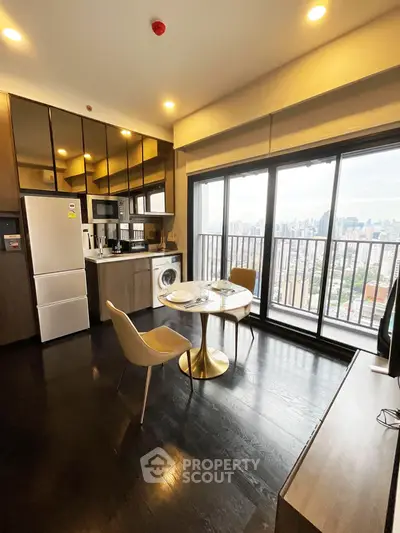 Modern kitchen with city view, featuring sleek appliances and stylish dining area.