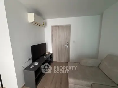 Cozy living room with modern TV setup and comfortable sofa, perfect for relaxation.