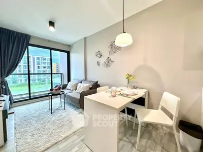 Modern living room with large windows and stylish decor in a high-rise apartment.