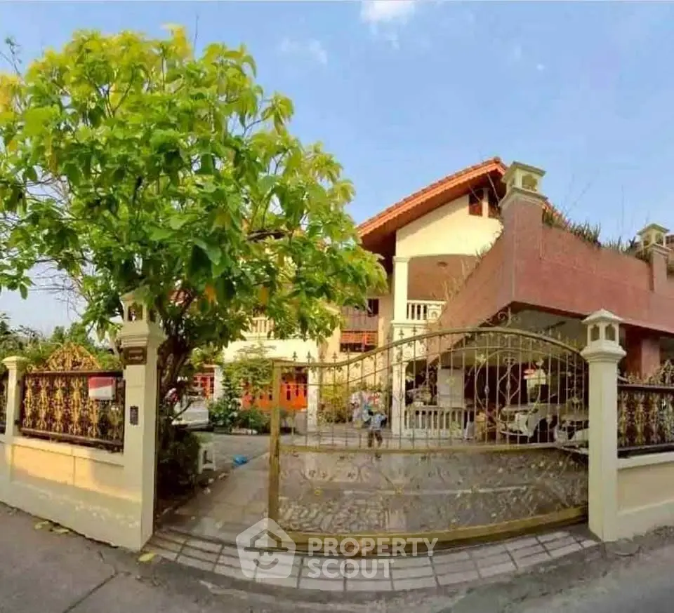 Charming suburban house with lush garden and gated entrance, perfect for family living.