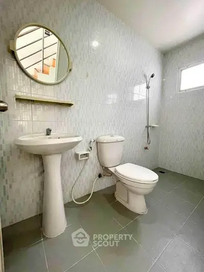 Spacious bathroom with modern fixtures and natural light.