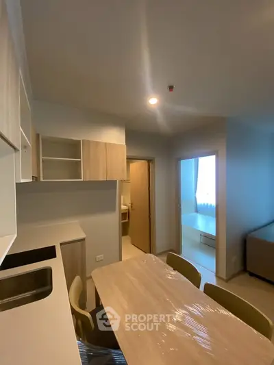 Modern kitchen and dining area with sleek design and ample natural light.