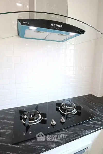 Modern kitchen with sleek gas stove and stylish range hood