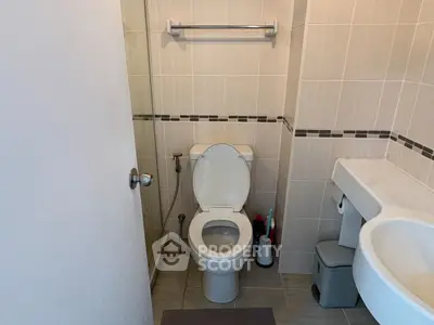 Modern bathroom with sleek fixtures and neutral tile design.