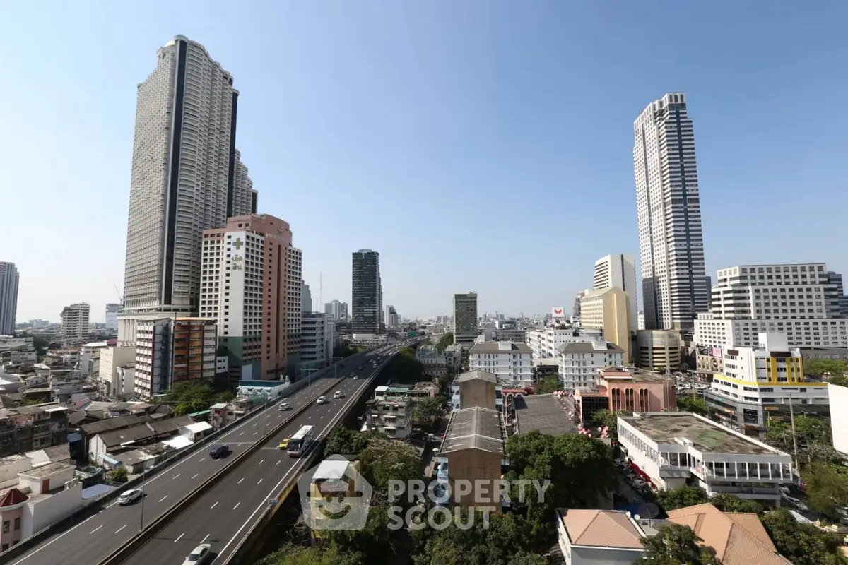Stunning cityscape view with towering skyscrapers and bustling highway, showcasing urban living at its finest.