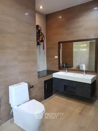 Modern bathroom with sleek fixtures and large mirror