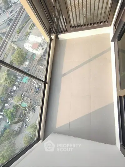 Spacious balcony with panoramic city view, perfect for relaxation and enjoying urban scenery.